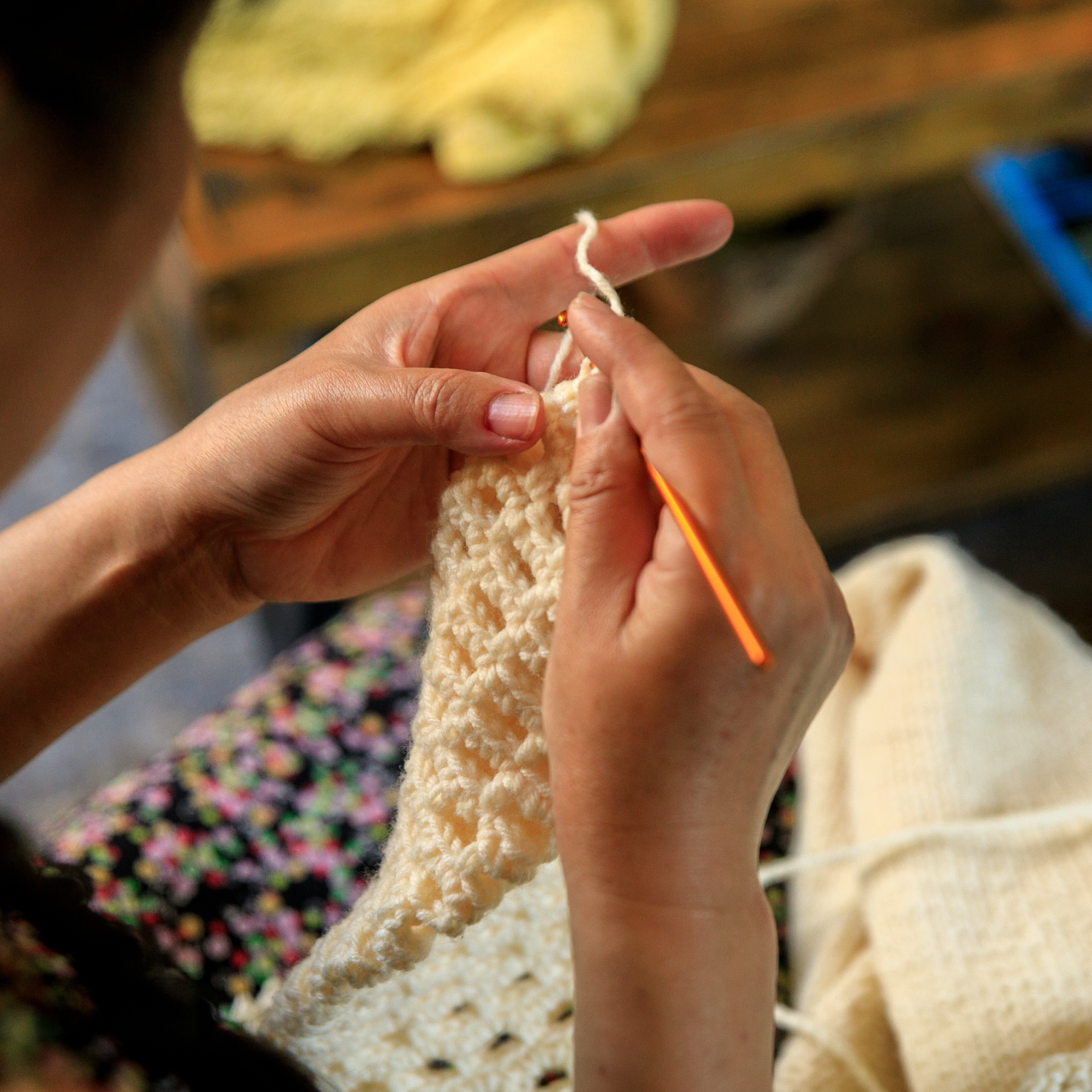 Photo depicting someone crocheting with white yarn.