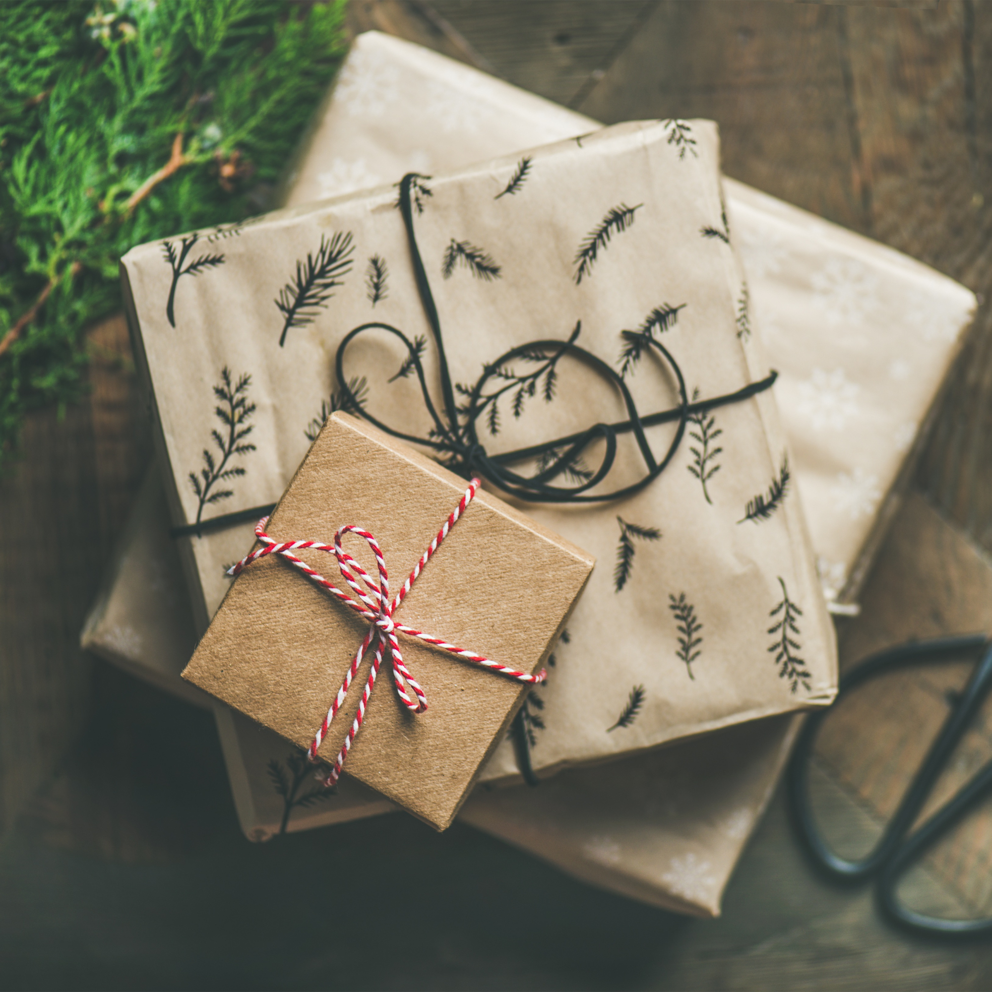 Stack of wrapped presents with embellishments.