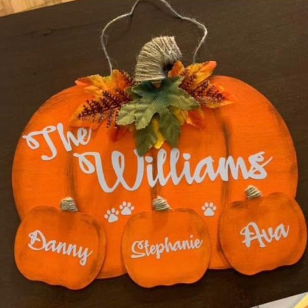 large Pumpkin with Family name and three small pumpkins with first names