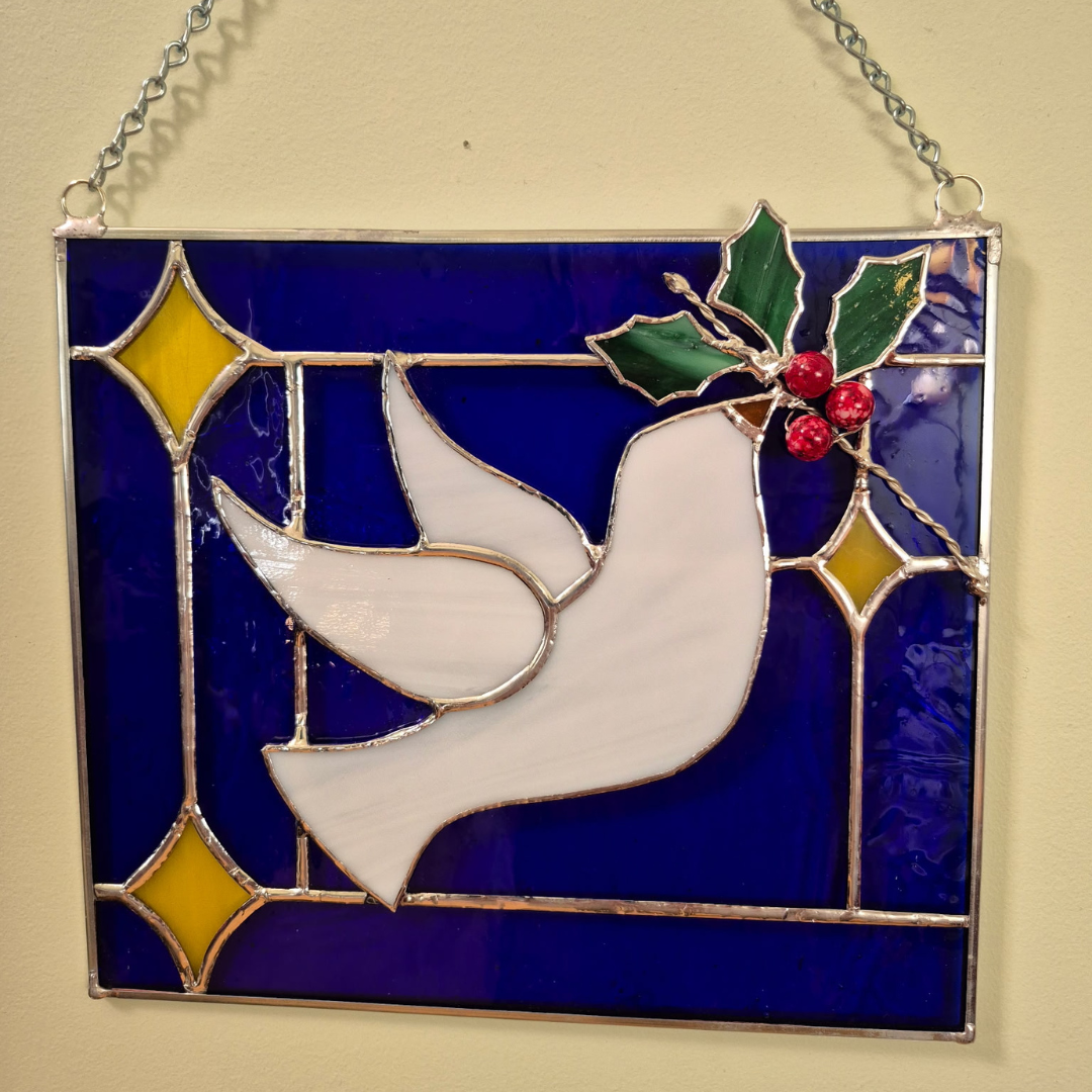 Stain glass of white dove and blue back round
