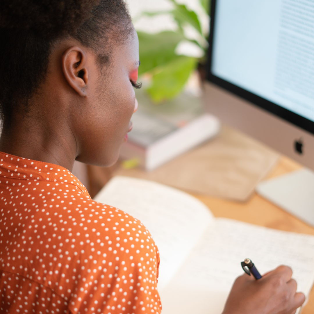 A woman writing in a journal