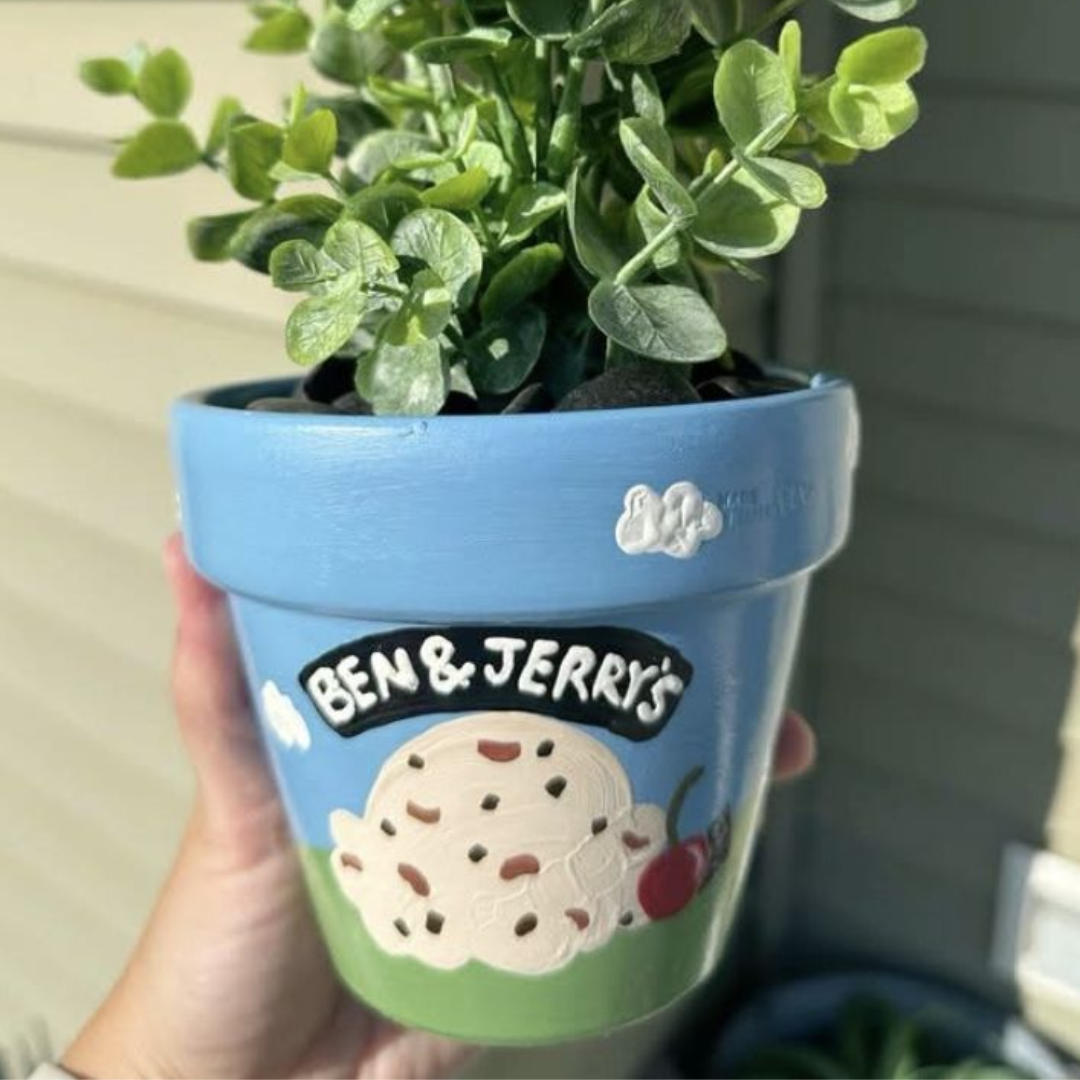 small clay painted pot with herbs