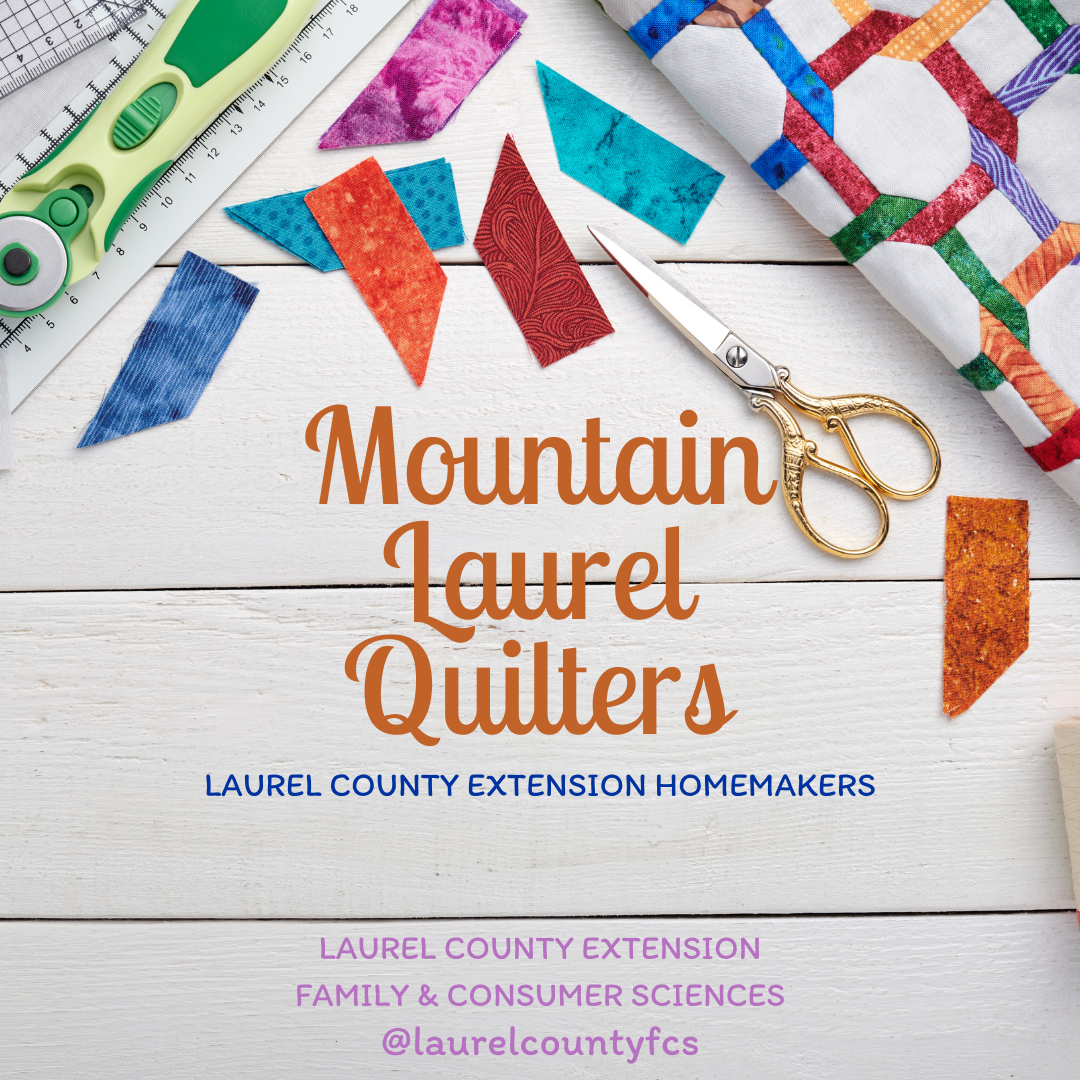 Background picture includes wood table top with quilt, scissors, fabric pieces, and rotary cutter laying on it. Wording states "Mountain Laurel Quilters: Laurel County Extension Homemakers"