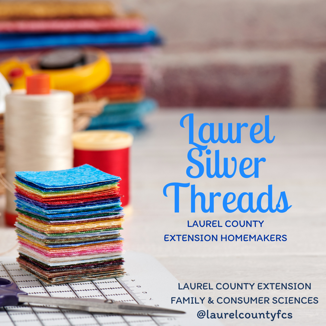Table with fabric, thread, and other sewing materials stacked. Wording states "Laurel Silver Threads: Laurel County Extension Homemakers"