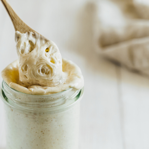 Sourdough starter with wooden spoon.