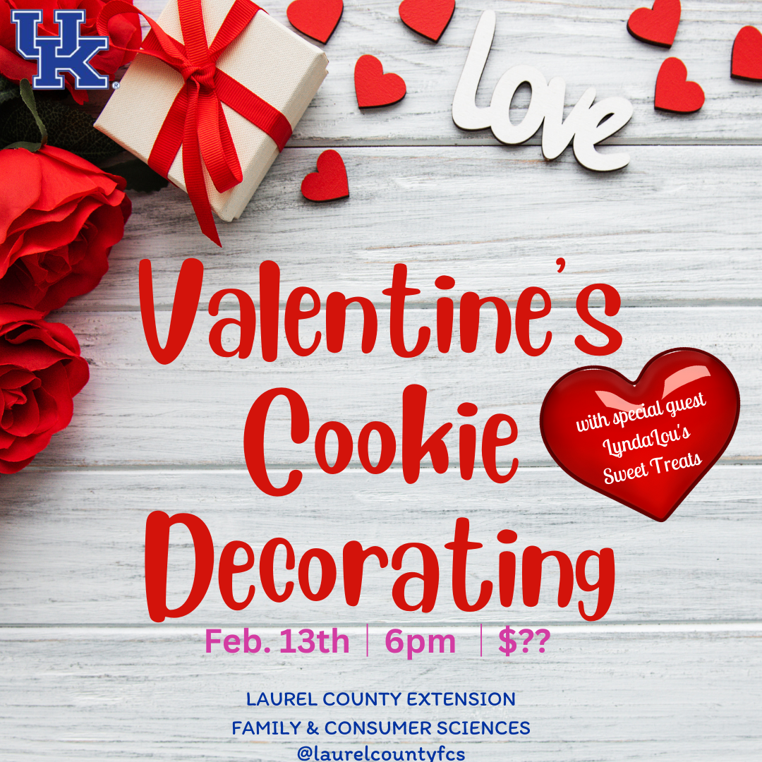 Wood table with valentine's themed items (roses, presents, hearts) with the wording "Valentine's Cookie Decorating
